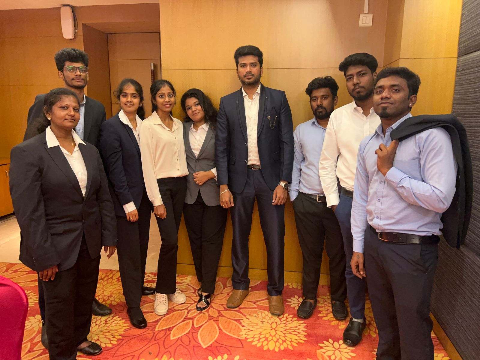 Ten members of Missan's India team in formal wear standing together in a hotel function room