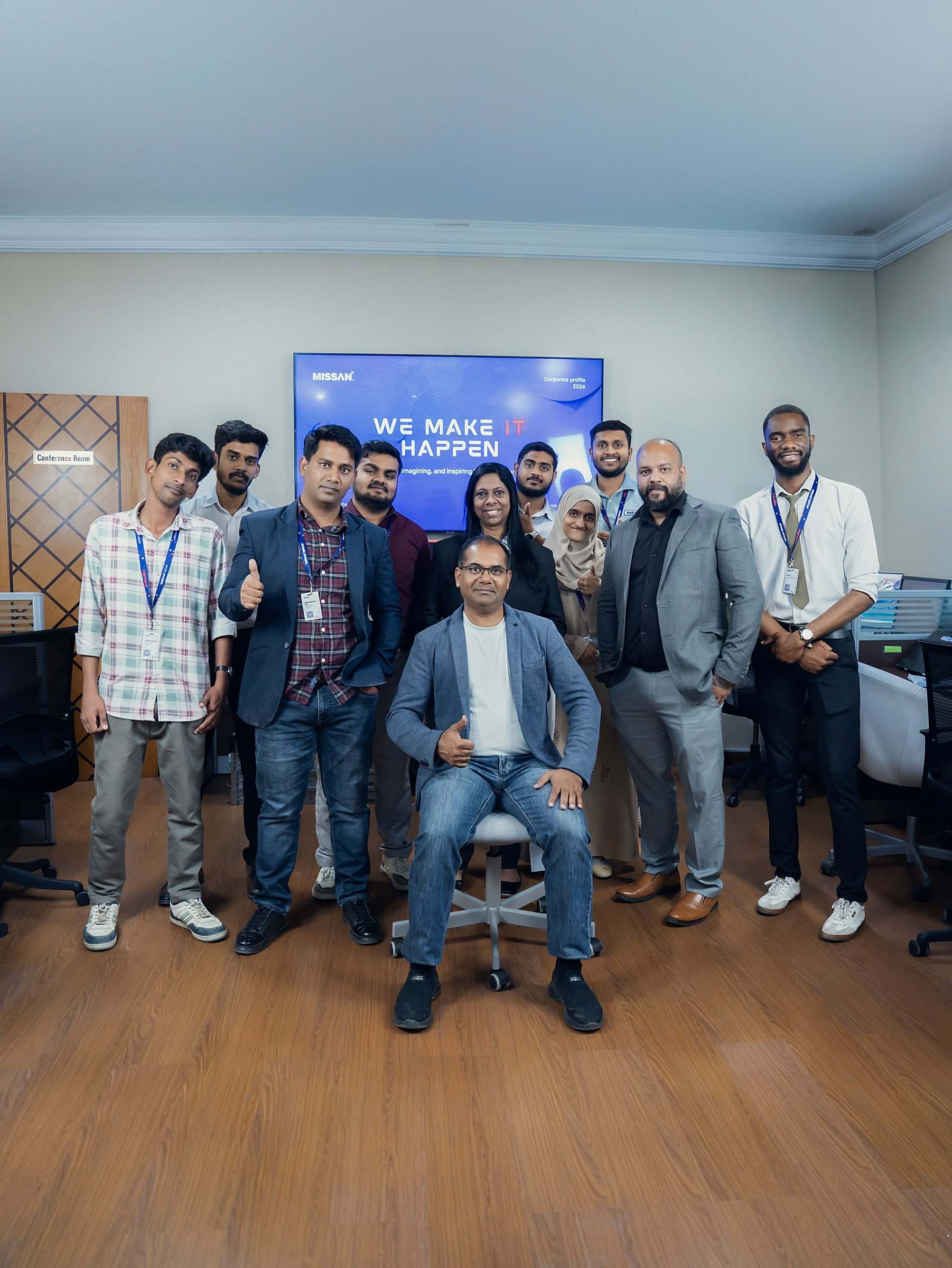 Missan engineers and staff together in the Sharjah office, giving a thumbs-up