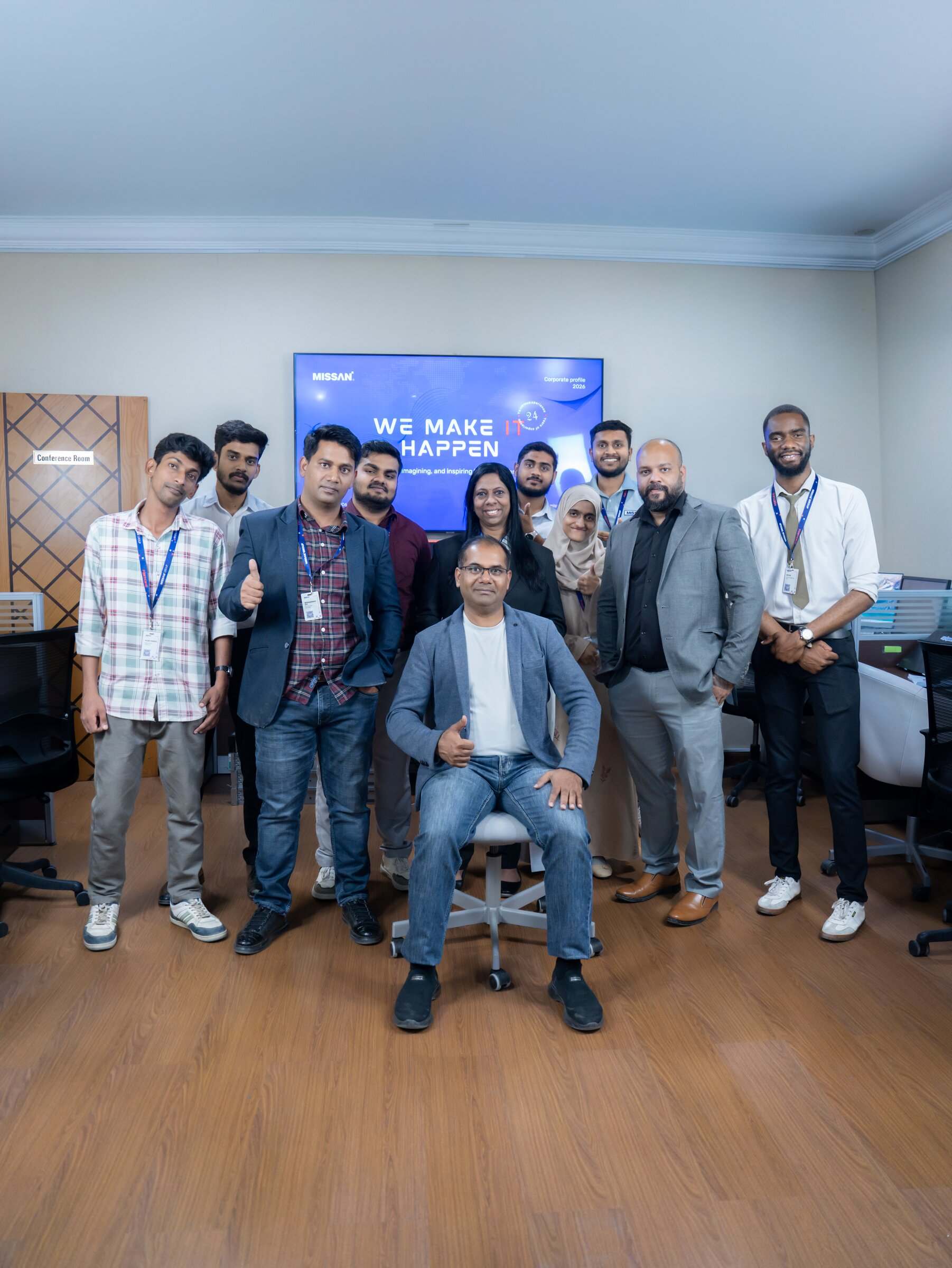 Missan engineers and staff together in the Sharjah office, giving a thumbs-up