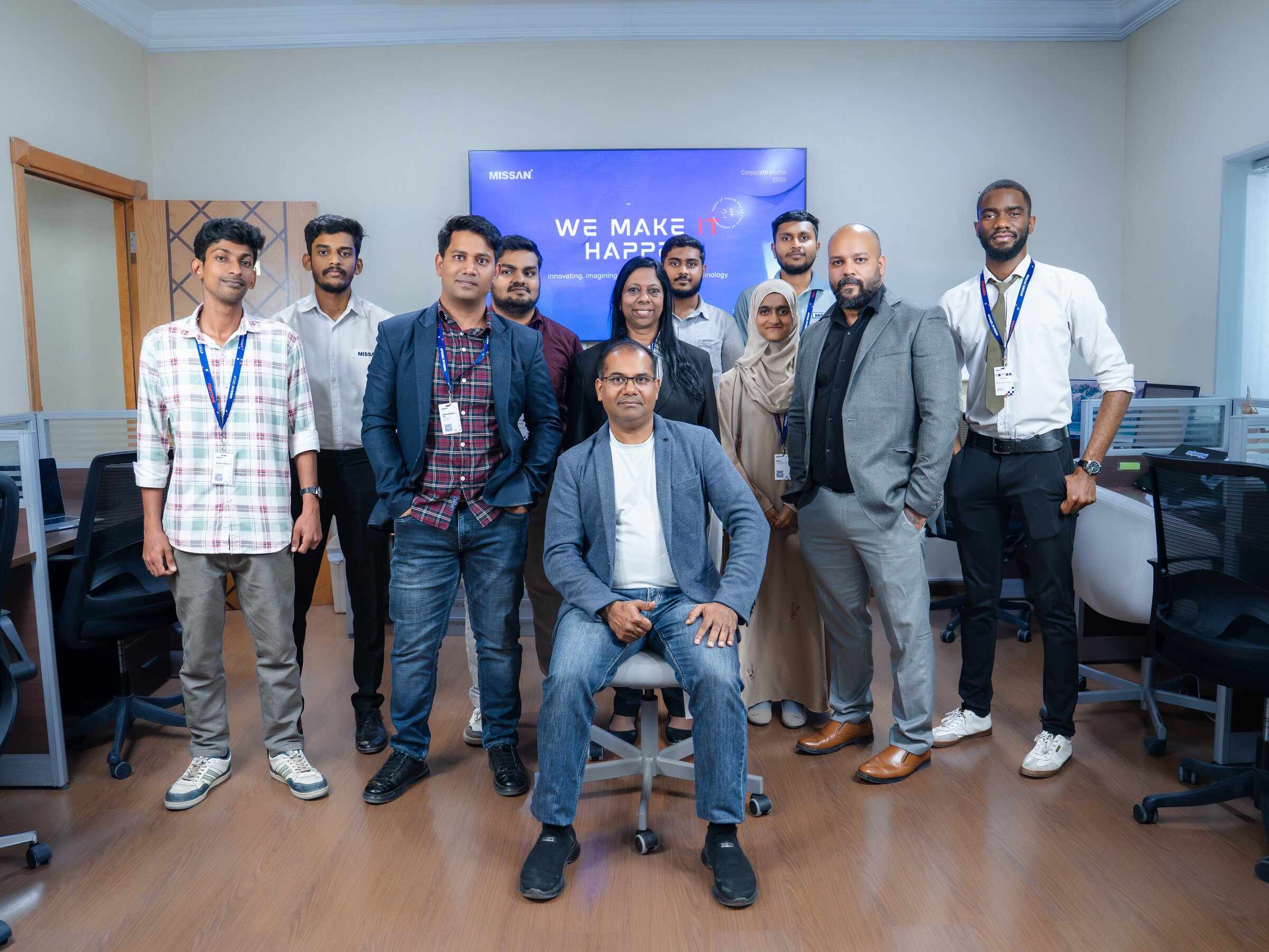 The Missan team at the Sharjah head office, with founder and CEO Abu Amir seated in front of a "We make IT happen" screen