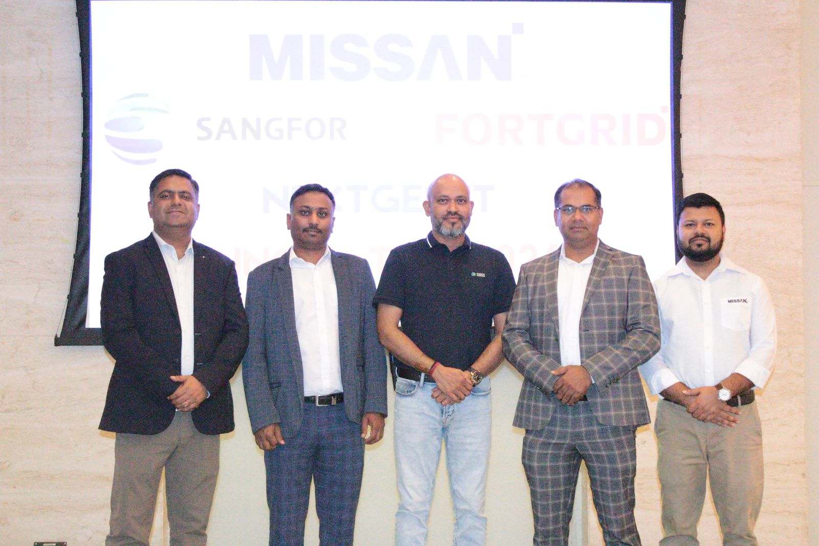 Five men standing in front of a large screen showing the Missan, Sangfor and FortGrid logos